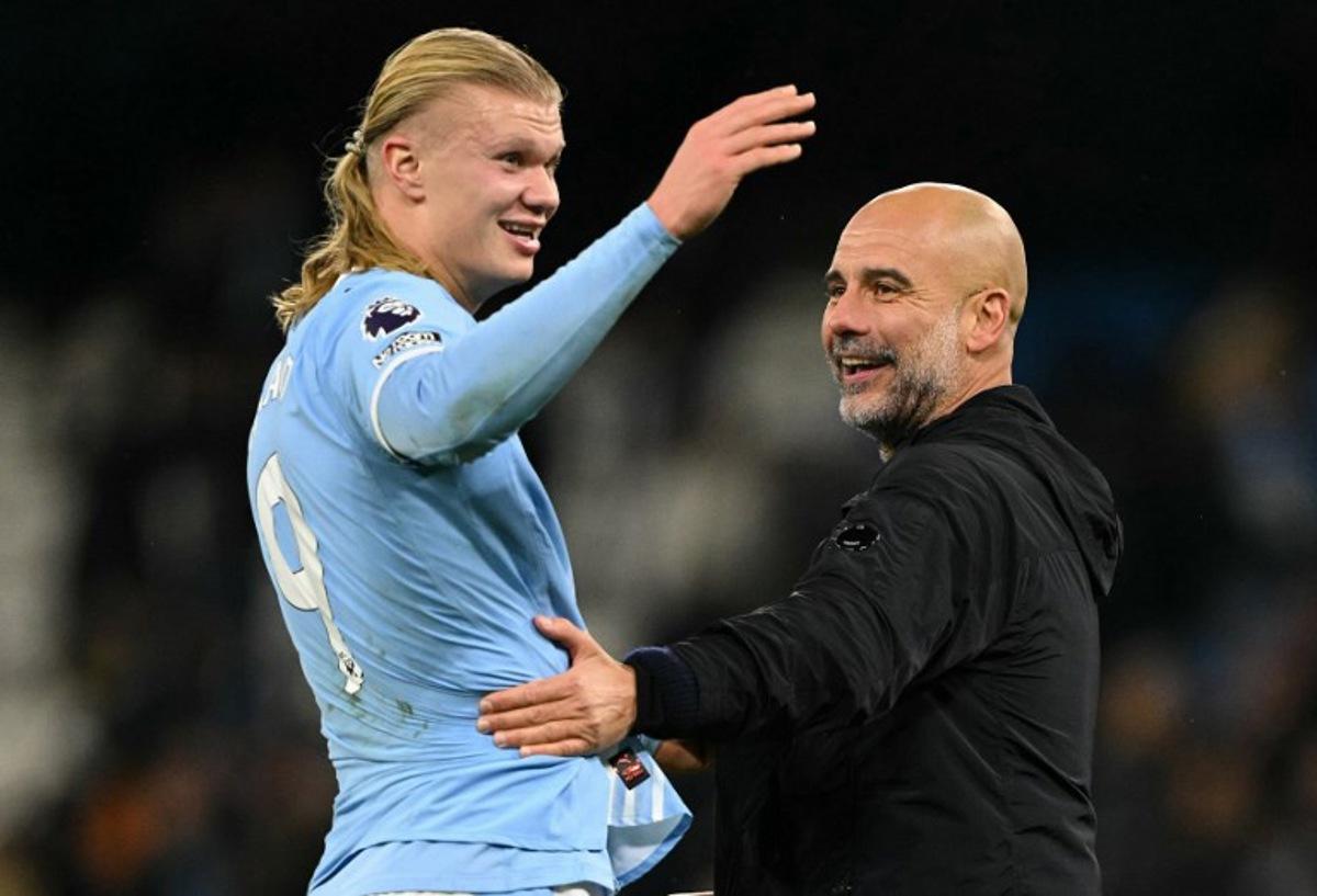 Manchester City's Norwegian striker #09 Erling Haaland (L) reacts with Manchester City's Spanish manager Pep Guardiola after the English Premier League football match between Manchester City and Leeds United at the Etihad Stadium in Manchester, north west England, on November 29, 2025. Oli SCARFF / AFP