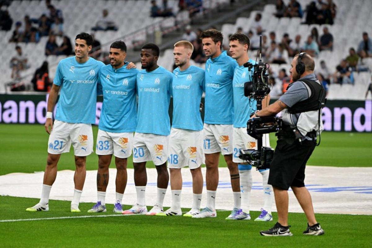 Marseilles new players (From L) Marseille's Maroccan defender #21 Nayef Aguerd, Marseille's Italian defender #33 Emerson Palmieri, Marseille's Ivorian midfielder #20 Hamed Junior Traore, Marseille's Belgian midfielder #18 Arthur Vermeeren, Marseille's Danish midfielder #17 Matt O'Riley and Marseille's French defender #28 Benjamin Pavard pose prior to the French L1 football match between Olympique de Marseille (OM) and FC Lorient at the Stade Velodrome in Marseille, southern France on September 12, 2025. Christophe Simon / AFP