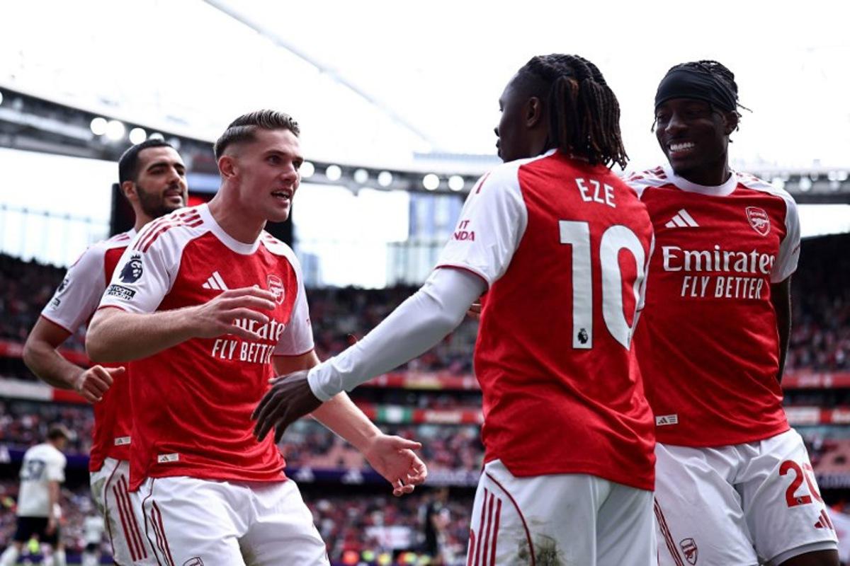 Arsenal's Swedish striker #14 Viktor Gyokeres celebrates scoring the team's second goal with Arsenal's English midfielder #10 Eberechi Eze during the English Premier League football match between Arsenal and Nottingham Forest at the Emirates Stadium in London on September 13, 2025. HENRY NICHOLLS / AFP