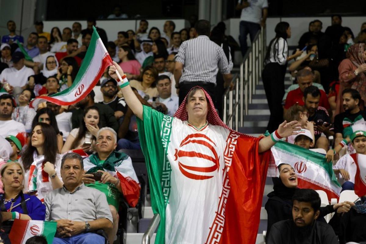 An Iran fan cheers ahead of the 2026 FIFA World Cup Asian Qualifier football match between Qatar and Iran at Jassim Bin Hamad Stadium in Doha on June 5, 2025. Karim JAAFAR / AFP