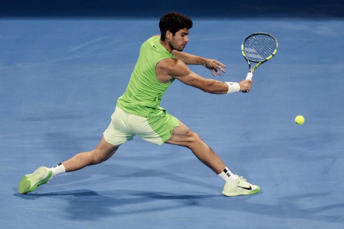 Spain's Carlos Alcaraz hits a return against France's Arthur Fils during their men's singles final match at the Qatar Open tennis tournament in Doha on February 21, 2026. Karim JAAFAR / AFP