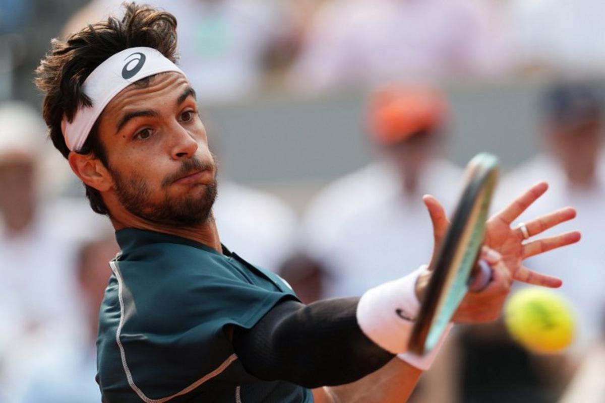 Italy's Lorenzo Musetti plays a forehand return to US Frances Tiafoe during their men's singles quarter-final match on day 10 of the French Open tennis tournament on Court Philippe-Chatrier at the Roland-Garros Complex in Paris on June 3, 2025. Dimitar DILKOFF / AFP