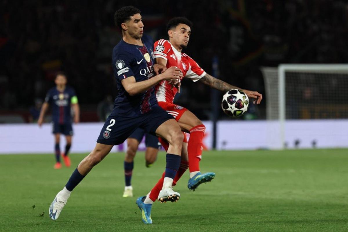 Paris Saint-Germain's Moroccan defender #02 Achraf Hakimi fights for the ball with Bayern Munich's Colombian forward #14 Luis Diaz during the UEFA Champions League semi-final first leg football match between Paris Saint-Germain (PSG) and Bayern Munich at the Parc des Princes in Paris on April 28, 2026. Anne-Christine POUJOULAT / AFP