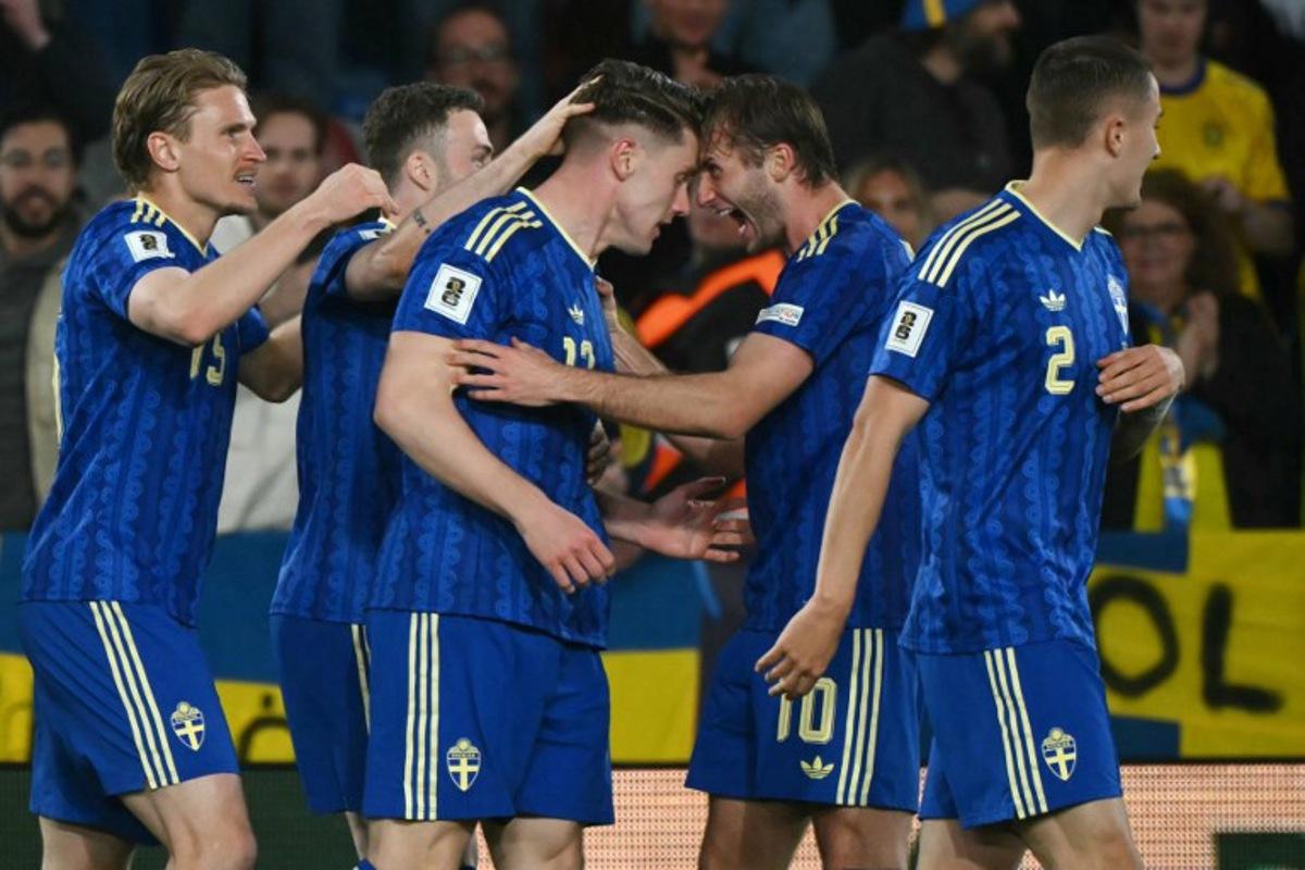 Sweden's forward #17 Viktor Gyokeres (3L) celebrates scoring his team's second goal with Sweden's forward #10 Benjamin Nygren (2R) during the 2026 World Cup qualifiers Europe zone semifinal football match between Ukraine and Sweden at Ciutat de Valencia Stadium in Valencia on March 26, 2026. JOSE JORDAN / AFP