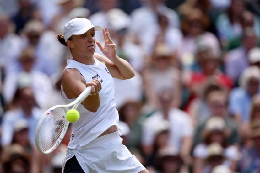Poland's Iga Swiatek returns to Philippines' Alexandra Eala during their women's singles third round tennis match on the sixth day of the 2026 Wimbledon Championships at The All England Lawn Tennis and Croquet Club in Wimbledon, southwest London, on July 4, 2026. Henry Nicholls / AFP