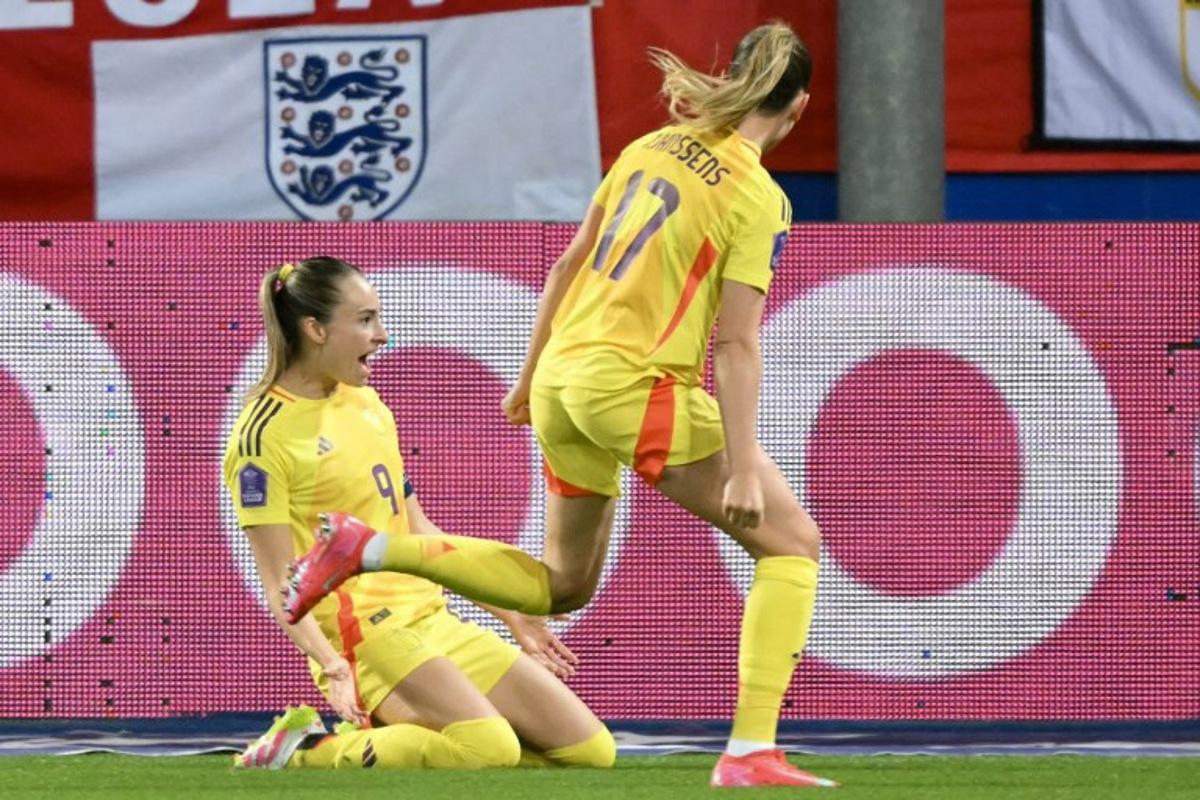 Belgium's forward #09 Tessa Wullaert (L) celebrates scoring her team's third goal during the UEFA Women's Nations League Group A3 football match between Belgium and England at the Den Dreef stadium in Heverlee, outside Leuven, on April 8, 2025. NICOLAS TUCAT / AFP