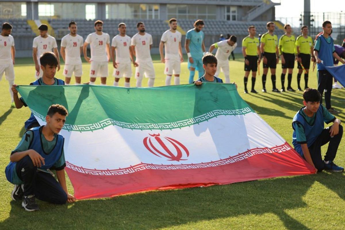 Iran's players stand behind the flag of Iran for photographers before the start of an international friendly football match between Iran and Gambia, in Antalya, southern Turkey, on May 29, 2026, as part of the team's preparation for the upcoming football World Cup. Oner SAN / AFP