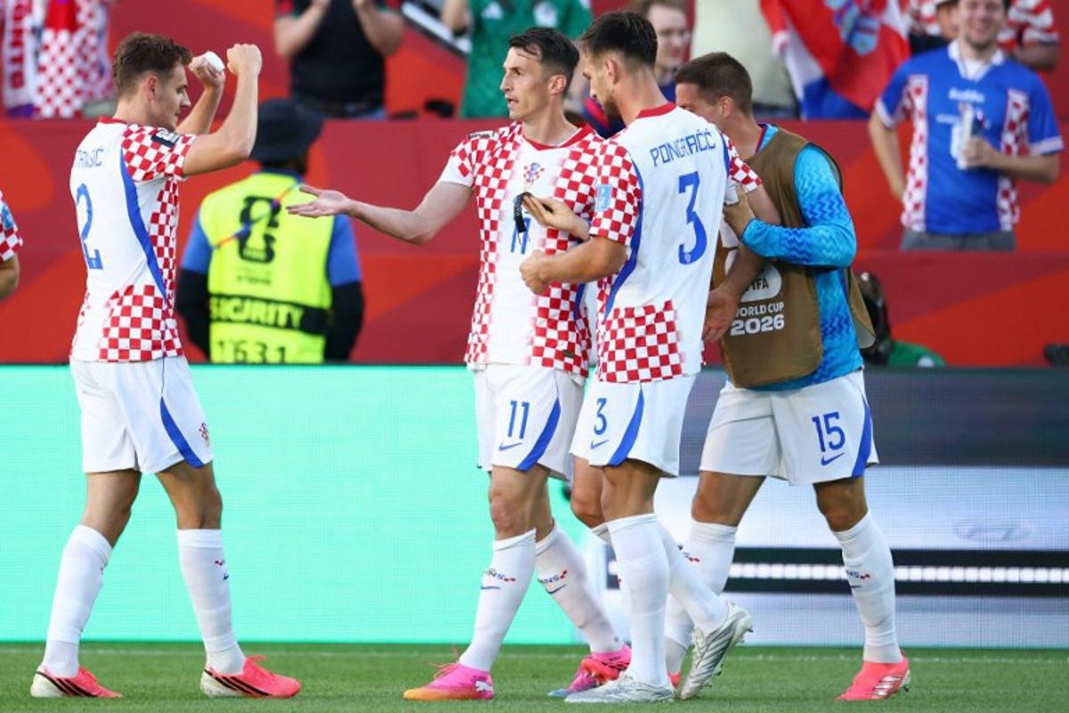 Croatia's forward #11 Ante Budimir celebrates with teammates scoring his team's first goal during the 2026 World Cup Group L football match between Panama and Croatia at the Toronto Stadium in Toronto on June 23, 2026. Cole Burston / AFP