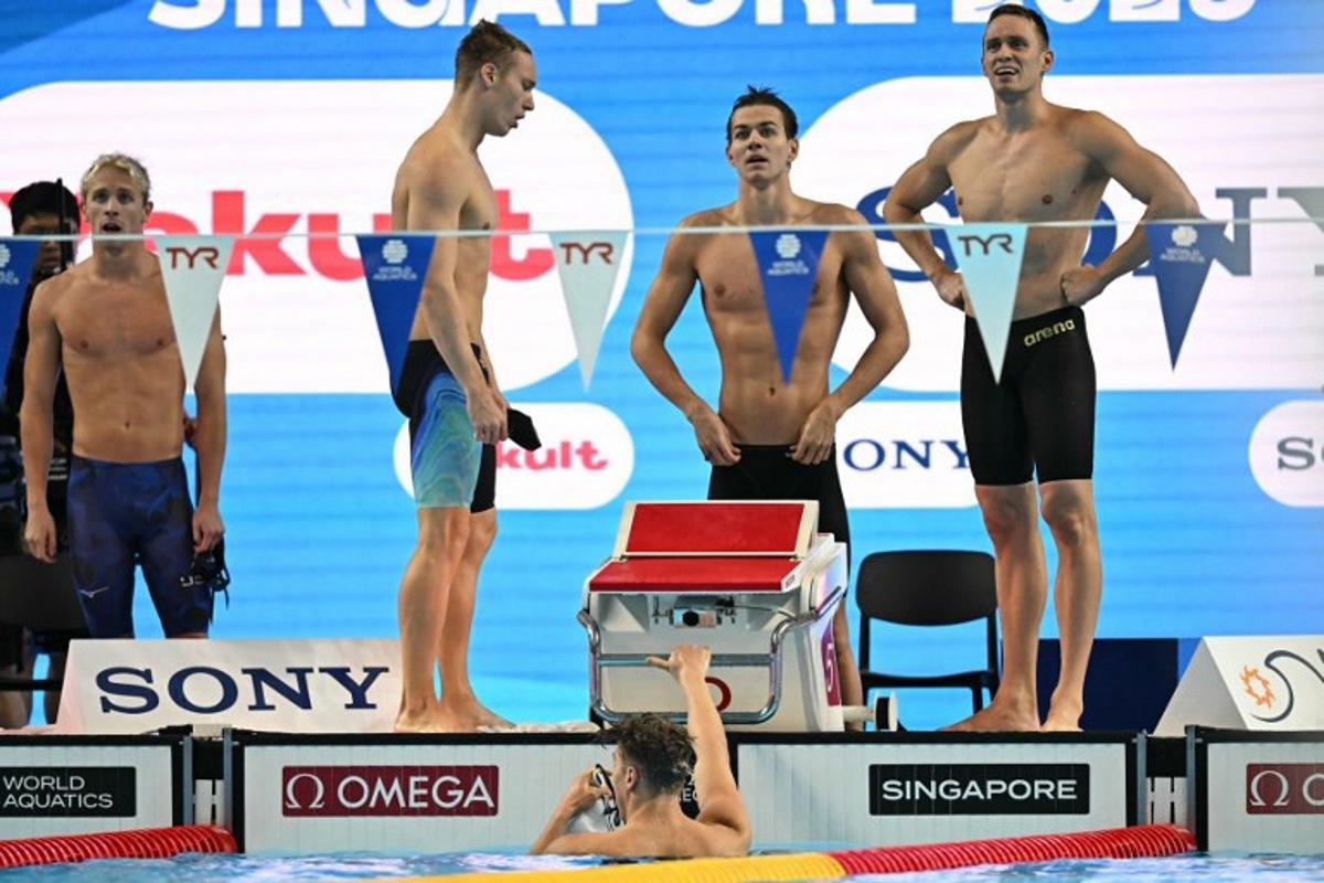 Neutral Athlete's team Neutral Athlete swimmer Andrei Minakov, Neutral Athlete swimmer Miron Lifintsev, Neutral Athlete swimmer Kirill Prigoda and Neutral Athlete swimmer Egor Kornev react after winning the men's 4x100m medley relay swimming event during the 2025 World Aquatics Championships in Singapore on August 3, 2025. Manan VATSYAYANA / AFP