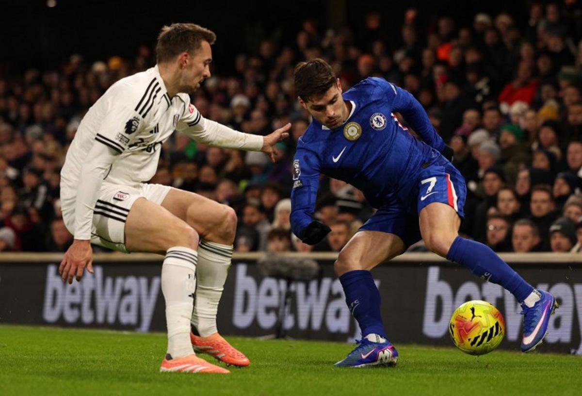 Fulham's Belgian defender #21 Timothy Castagne (L) vies with Chelsea's Portuguese midfielder #07 Pedro Neto during the English Premier League football match between Fulham and Chelsea at Craven Cottage in London on January 7, 2026. Adrian Dennis / AFP