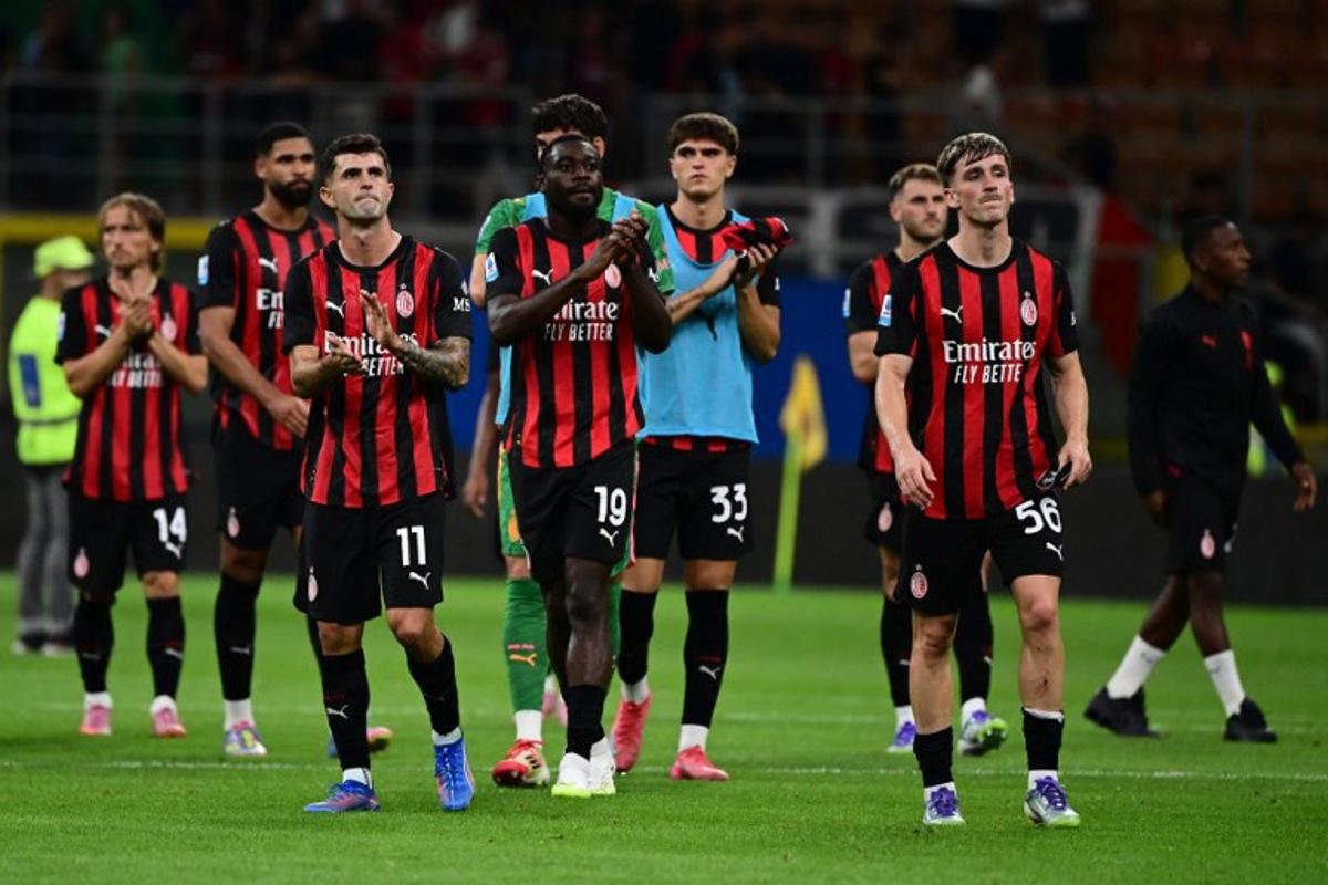 AC Milan's Croatian midfielder #14 Luka Modric, AC Milan's US forward #11 Christian Pulisic, AC Milan's French midfielder #19 Youssouf Fofana, AC Milan's Italian defender #33 Davide Bartesaghi and AC Milan's Begian midfielder #56 Alexis Saelemaekers greet fans at the end of the Italian Serie A football match between AC Milan and Cremonese at San Siro stadium in Milan, on August 23, 2025. PIERO CRUCIATTI / AFP