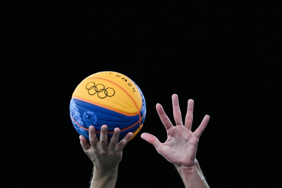 Players try to grab the ball in the men's 3x3 basketball play-in games between Serbia and France during the Paris 2024 Olympic Games at La Concorde in Paris on August 4, 2024. Luis ROBAYO / AFP