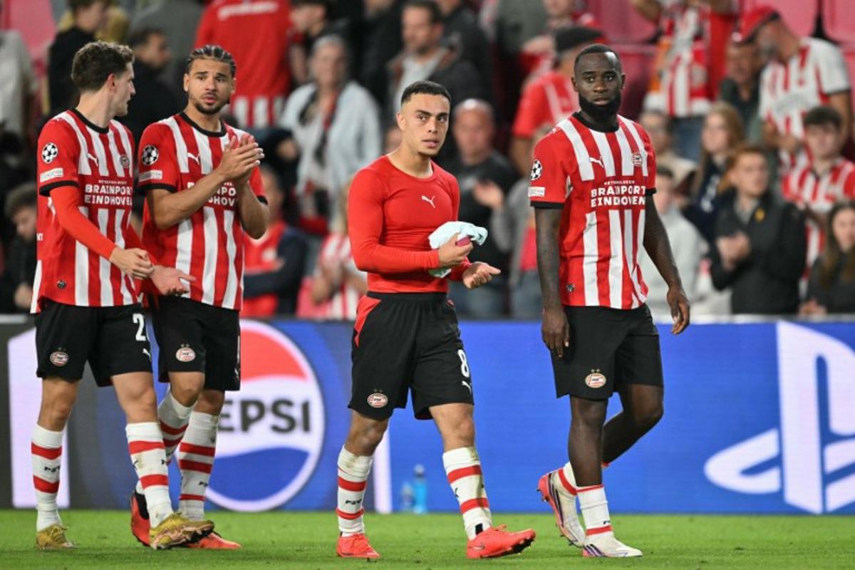 (From L) PSV Eindhoven's Dutch midfielder #20 Guus Til, PSV Eindhoven's Curacaoan defender #04 Armando Obispo, PSV Eindhoven's US defender #08 Sergino Dest and Lutsharel PSV Eindhoven's Dutch defender #02 Lutsharel Geertruida react after a draw in the UEFA Champions League - League phase, Matchday 1 - football match between PSV Eindhoven and FC Shakhtar Donetsk at the Philips Stadium in Eindhoven on September 10, 2026. NICOLAS TUCAT / AFP