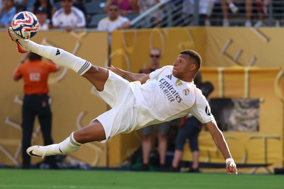 Real Madrid's French forward #09 Kylian Mbappe scores his team's third goal during the FIFA Club World Cup 2025 quarterfinal football match between Spain's Real Madrid and Germany's Borussia Dortmund at the MetLife stadium in East Rutherford, New Jersey on July 5, 2025. CHARLY TRIBALLEAU / AFP