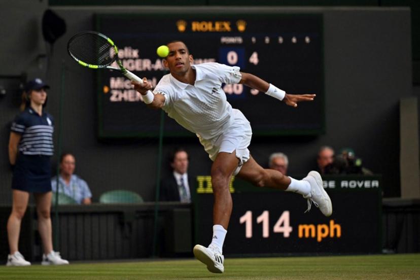 Canada's Felix Auger-Aliassime returns to US player Michael Zheng during their men's singles third round tennis match on the fifth day of the 2026 Wimbledon Championships at The All England Lawn Tennis and Croquet Club in Wimbledon, southwest London, on July 3, 2026. Glyn KIRK / AFP