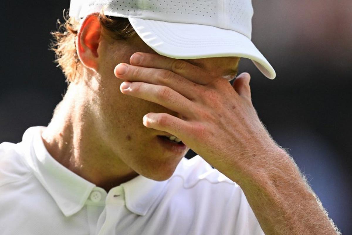 Italy's Jannik Sinner reacts as he plays against Spain's Carlos Alcaraz during their men's singles final tennis match on the fourteenth day of the 2025 Wimbledon Championships at The All England Lawn Tennis and Croquet Club in Wimbledon, southwest London, on July 13, 2025. Kirill KUDRYAVTSEV / AFP