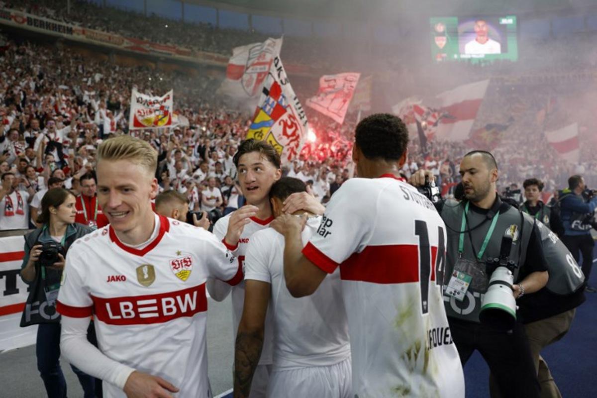 Stuttgart's French midfielder #08 Enzo Millot (C) celebrates scoring his team's fourth goal with teammates and Stuttgart fans during the German Cup (DFB Pokal) final football match between Arminia Bielefeld and VfB Stuttgart at the Olympic Stadium in Berlin on May 24, 2025. Odd ANDERSEN / AFP
