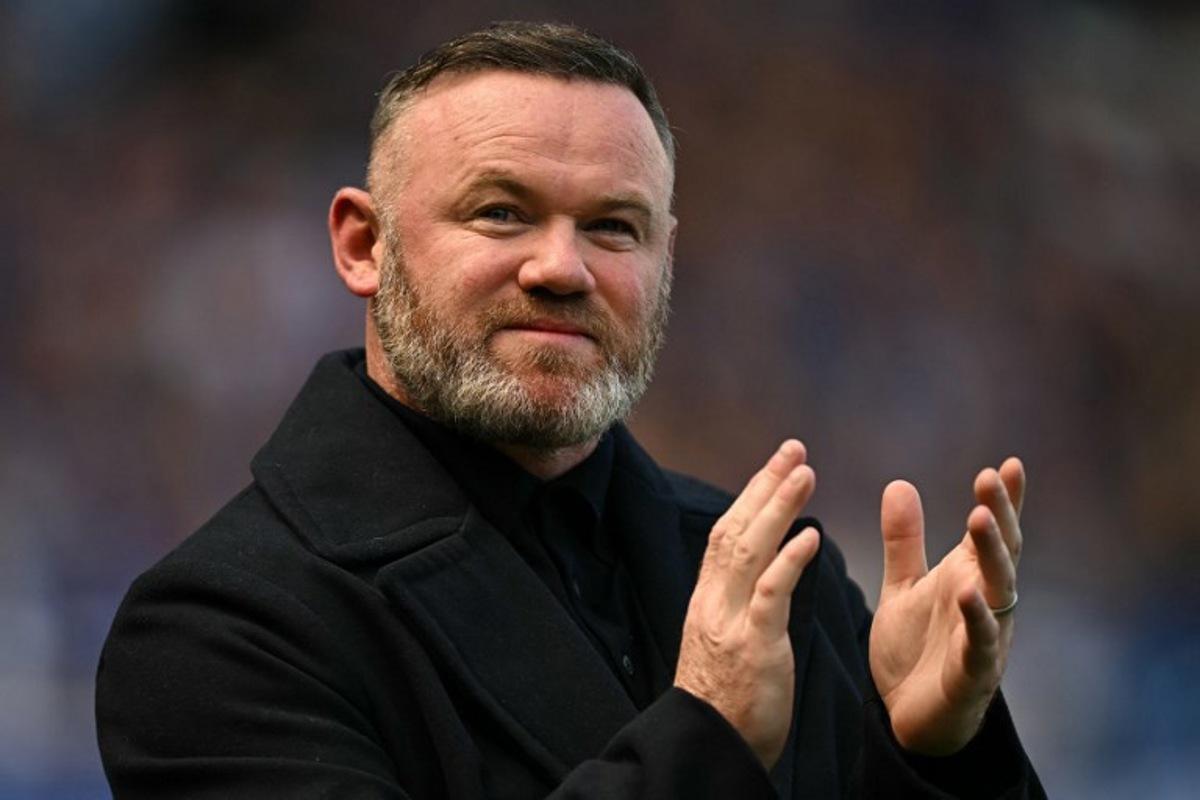 Former Everton player Wayne Rooney arrives on the pitch for the celebrations after the English Premier League football match between Everton and Southampton at Goodison Park in Liverpool, north west England on May 18, 2025, Everton's final premier league fixture played at the stadium, their home since 1892. Paul ELLIS / AFP