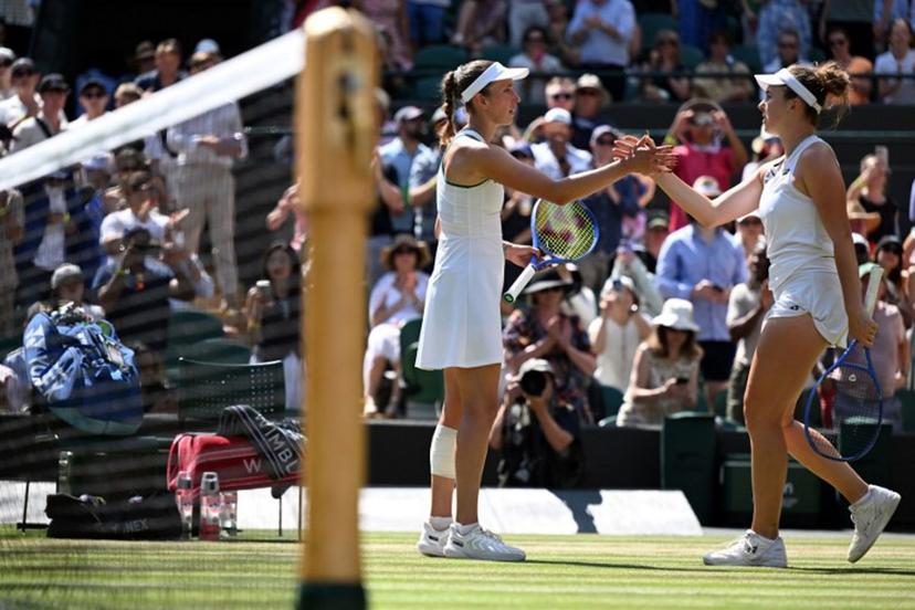 Czech Republic's Linda Noskova (R) is congratulated by Belgium's Elise Mertens for winning their women's singles quarter-final tennis match on the tenth day of the 2026 Wimbledon Championships at The All England Lawn Tennis and Croquet Club in Wimbledon, southwest London, on July 8, 2026. Kirill KUDRYAVTSEV / AFP