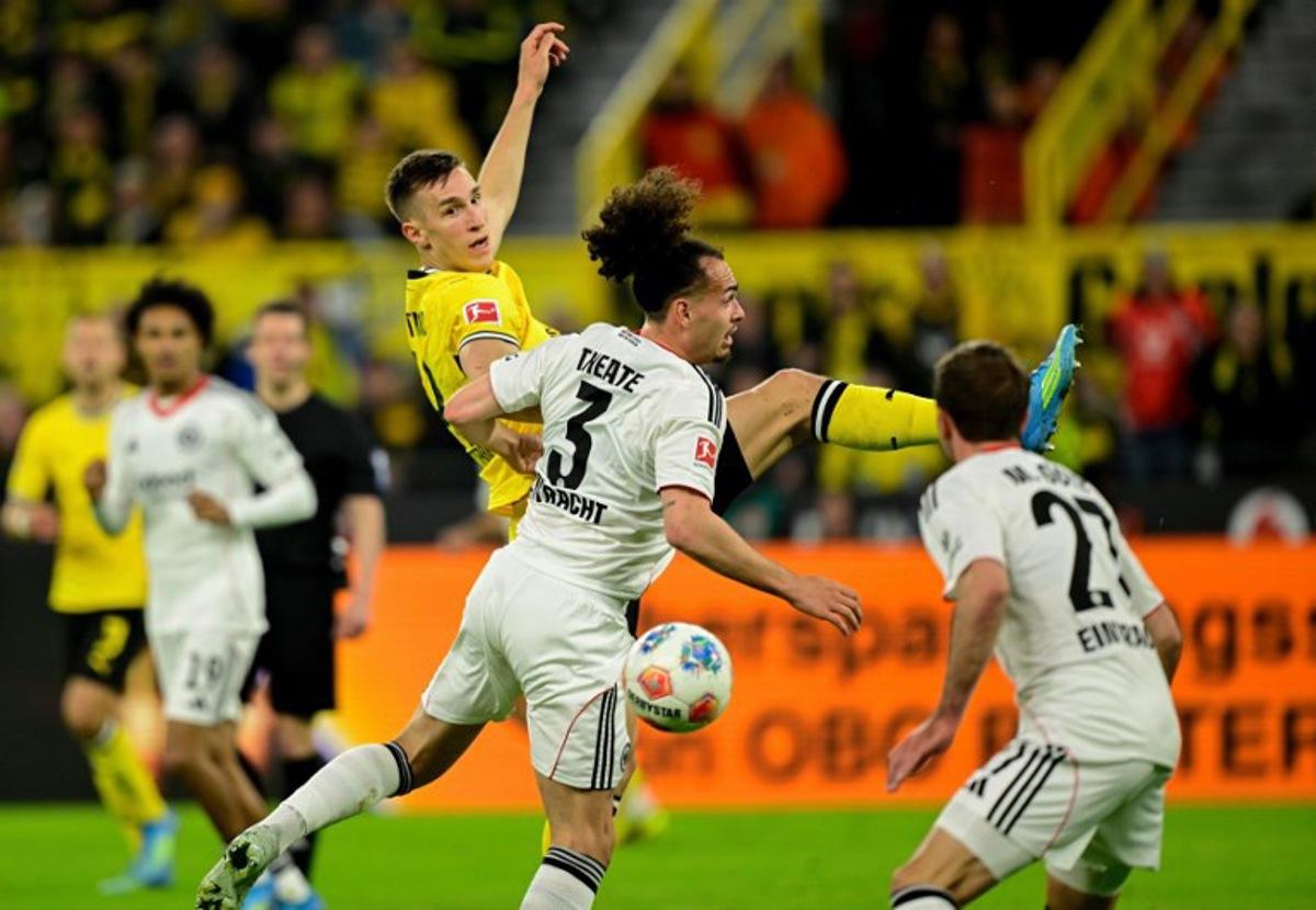 Dortmund's German defender #04 Nico Schlotterbeck and Frankfurt's Belgian defender #03 Arthur Theate vie for the ball during the German first division Bundesliga football match between BVB Borussia Dortmund and Eintracht Frankfurt in Dortmund, western Germany on May 8, 2026. INA FASSBENDER / AFP
