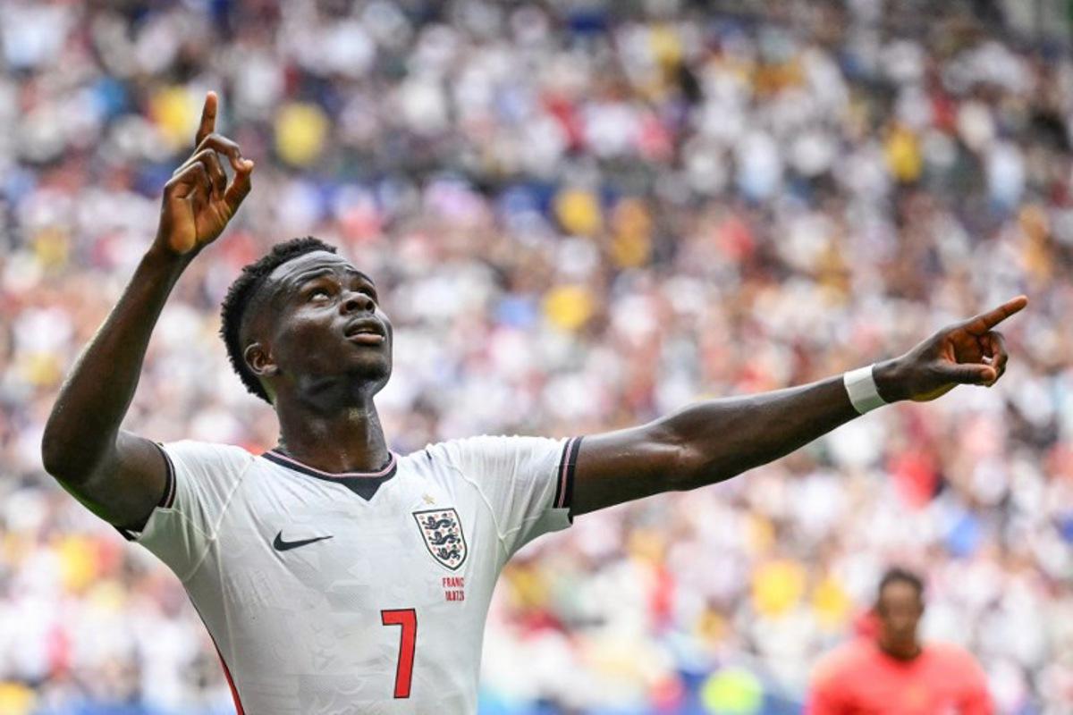 England's forward #07 Bukayo Saka celebrates scoring his team's fourth goal during the 2026 World Cup football tournament third-place match between France and England at the Miami Stadium in Miami on July 18, 2026. CHANDAN KHANNA / AFP