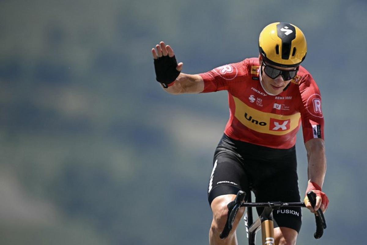 Uno-X Mobility team's Norwegian rider Jonas Abrahamsen cycles to the finish line of the 13th stage of the 112th edition of the Tour de France cycling race, 10.9 km individual time trial between Loudenvielle and Peyragudes, in the Pyrenees mountains of southwestern France, on July 18, 2025. Loic VENANCE / AFP