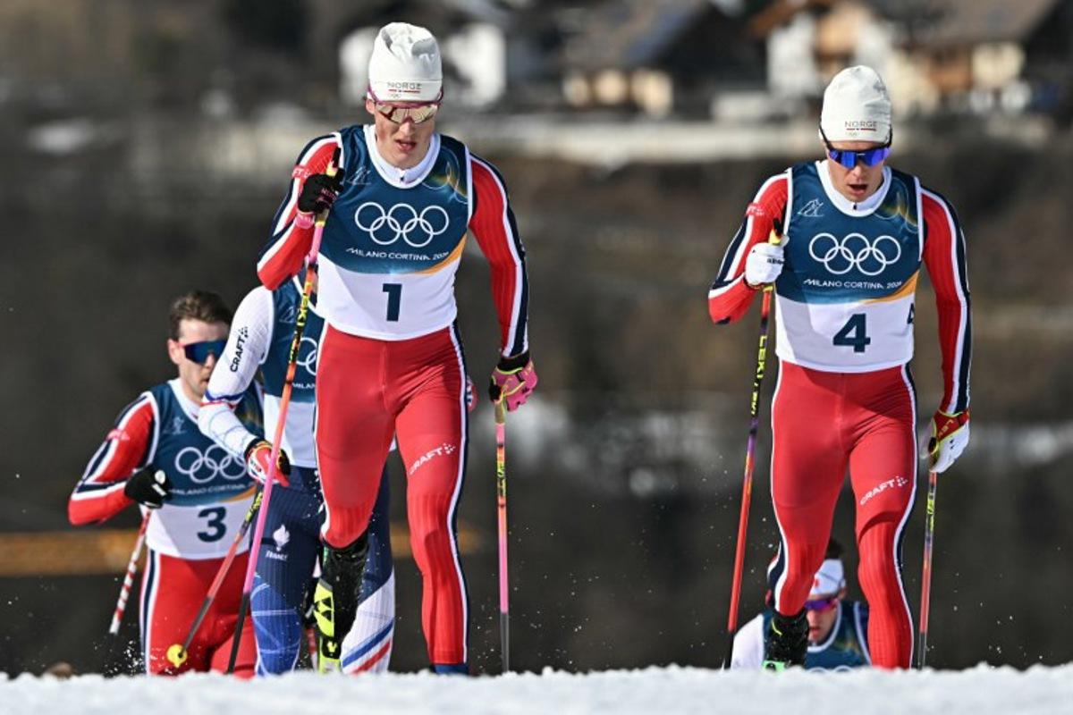 Norway's Johannes Hoesflot Klaebo (L) and Norway's Martin Loewstroem Nyenget compete during the men's cross country 10km + 10km skiathlon event of the Milano Cortina 2026 Winter Olympic Games at Tesero Cross-Country Skiing Stadium in Lago di Tesero (Val di Fiemme), on February 8, 2026. Javier SORIANO / AFP