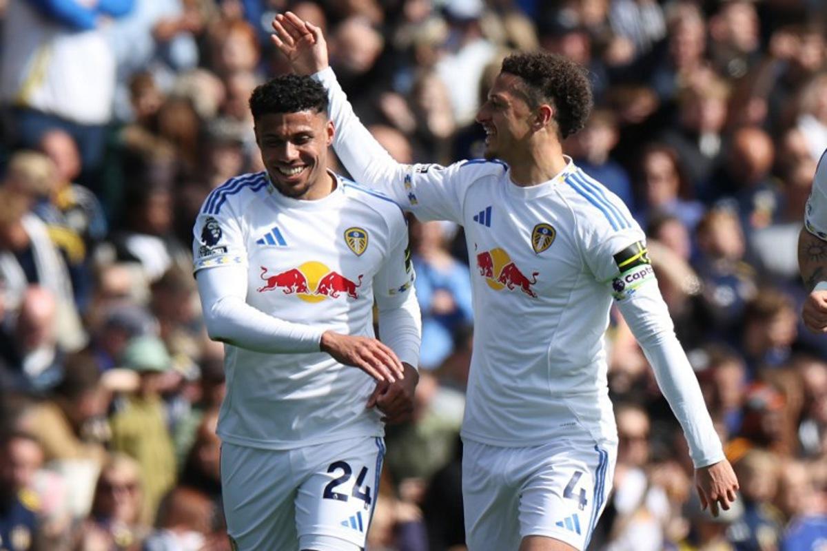 Leeds United's English defender #24 James Justin (L) celebrates with Leeds United's Welsh midfielder #04 Ethan Ampadu (R) after scoring the opening goal of the English Premier League football match between Leeds United and Wolverhampton Wanderers at Elland Road in Leeds, northern England on April 18, 2026. Darren Staples / AFP