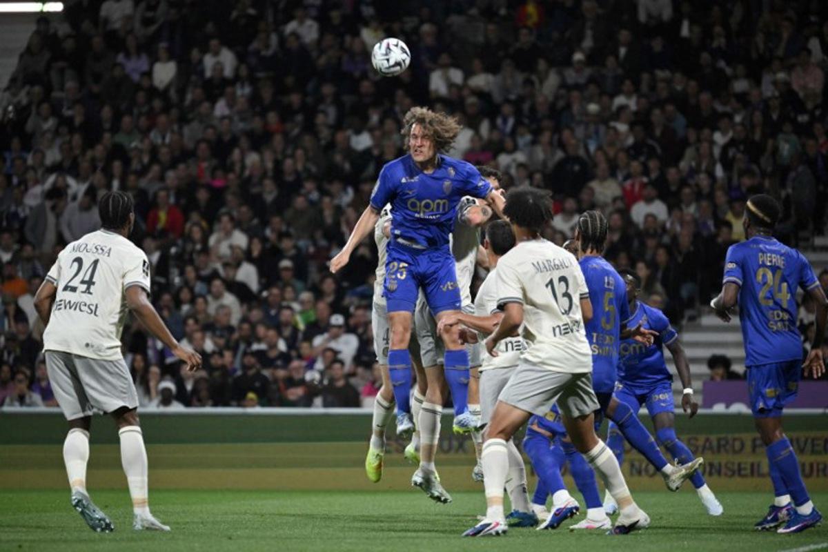 Monaco's Belgian defender #25 Wout Faes (C) heads the ball during the French L1 football match between Toulouse FC and AS Monaco at the TFC Stadium in Toulouse, southwestern France, on April 25, 2026. Ed JONES / AFP