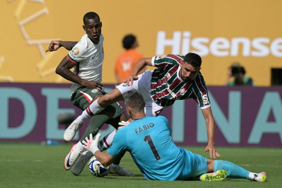 Chelsea's Senegalese striker #15 Nicolas Jackson fights for the ball with Fluminense's Brazilian defender #04 Ignacio and Brazilian goalkeeper #01 Fabio during the FIFA Club World Cup 2025 semifinal football match between Brazil's Fluminense and England's Chelsea at the MetLife stadium in East Rutherford, New Jersey on July 8, 2025. JUAN MABROMATA / AFP