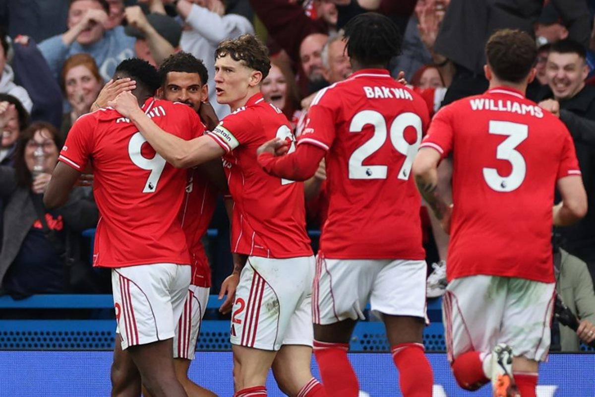 Nottingham Forest's Nigerian striker #09 Taiwo Awoniyi (L) celebrates with teammates after scoring his team's third goal during the English Premier League football match between Chelsea and Nottingham Forest at Stamford Bridge in London on May 4, 2026. Adrian Dennis / AFP