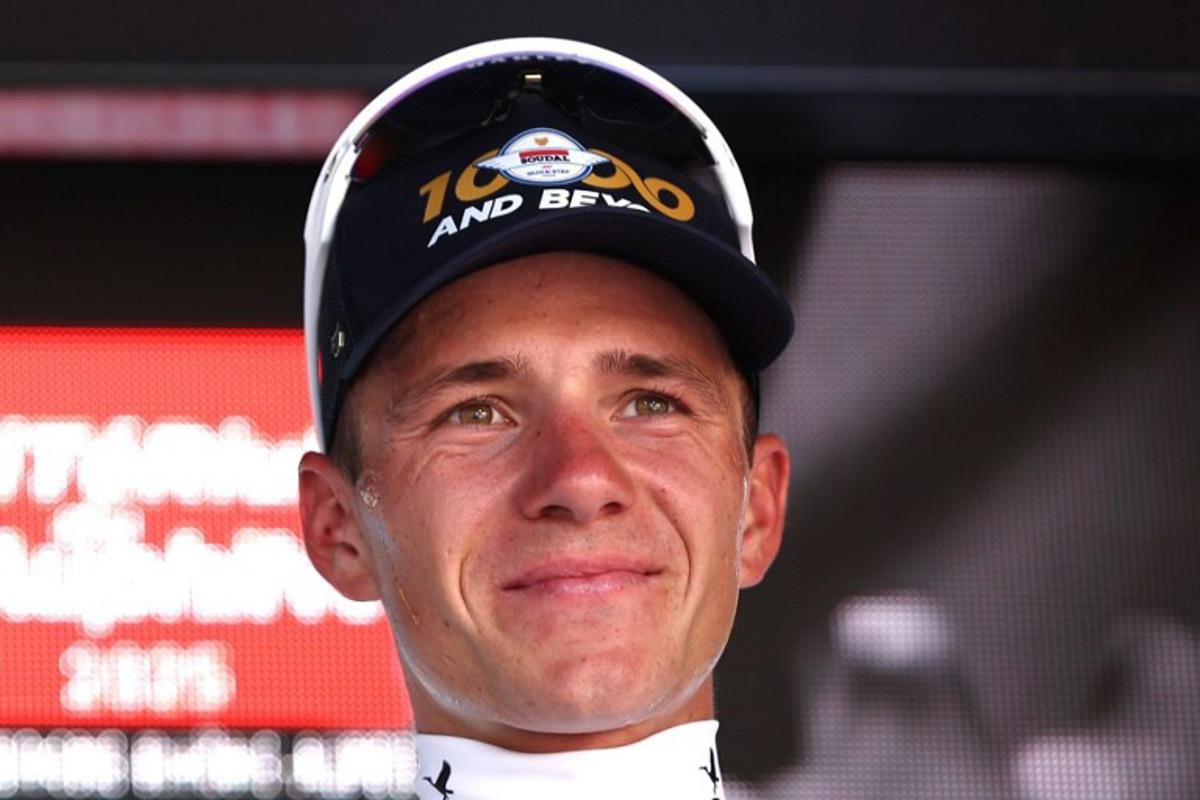 Soudal Quick-Step's Belgian rider Remco Evenepoel celebrates wearing the best young rider's white jersey after winning the stage on the podium of the 4th stage of the 77th edition of the Criterium du Dauphine cycling race, a 17,4 km individual time trial between Charmes-sur-Rhône and Saint-Péray, on June 11, 2025. Anne-Christine POUJOULAT / AFP