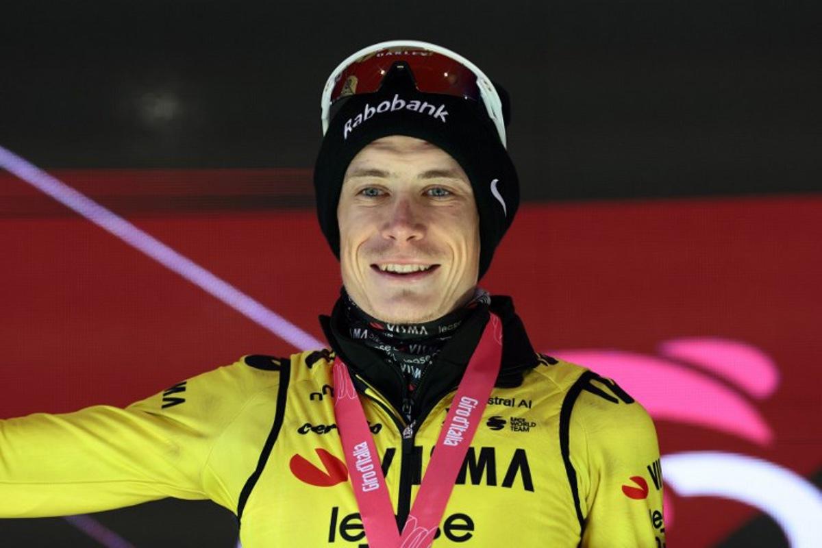 Team Visma Lease a Bike Danish rider Jonas Vingegaard, celebrates on the podium after winning the 9th stage of the Giro d'Italia 2026 - Tour of Italy cycling race between Cervia and Corno alle Scale, near Doganaccia, central Italy on May 17, 2026. Luca Bettini / AFP