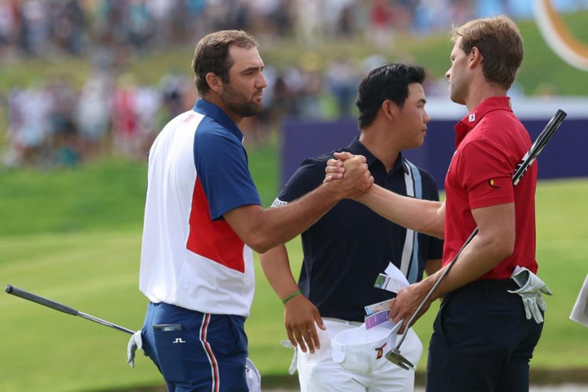 (From L) US' Scottie Scheffler, South Korea's Kim Jooh-yung and Belgium's Thomas Detry greet each other after completing the course in round 4 of the men's golf individual stroke play of the Paris 2024 Olympic Games at Le Golf National in Guyancourt, south-west of Paris on August 4, 2024. Emmanuel DUNAND / AFP