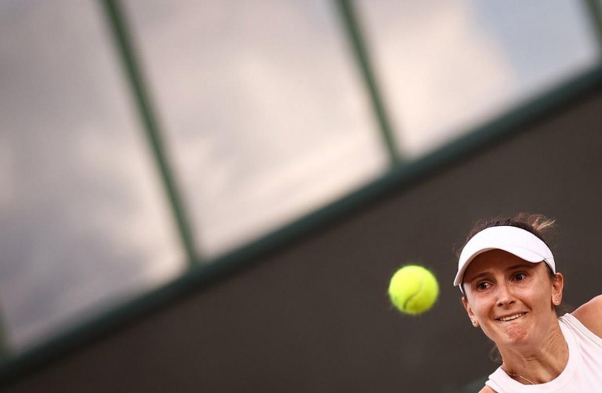 Romania's Irina-Camelia Begu eyes the ball as she returns it to Australia's Daria Kasatkina during their women's singles second round tennis match on the fourth day of the 2025 Wimbledon Championships at The All England Lawn Tennis and Croquet Club in Wimbledon, southwest London, on July 3, 2025. HENRY NICHOLLS / AFP