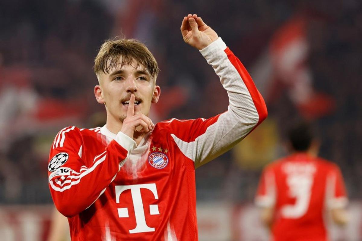 Bayern Munich's German midfielder #42 Lennart Karl celebrates scoring the 3-0 goal with his teammates during the UEFA Champions League, Round of 16 2nd-leg football match between FC Bayern Munich and Atalanta in Munich, southern Germany, on March 18, 2026. Alexandra BEIER / AFP