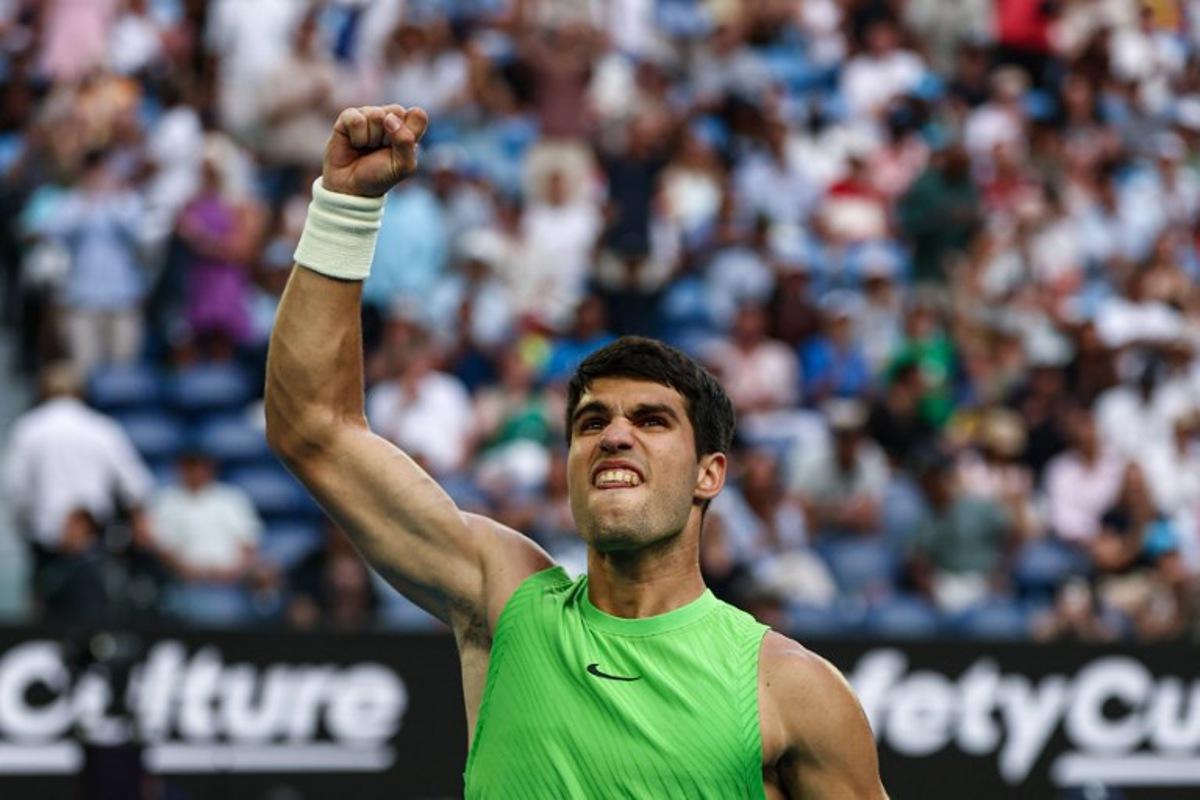 Spain's Carlos Alcaraz celebrates a point against Germany's Alexander Zverev during their men's singles semi-final match on day thirteen of the Australian Open tennis tournament in Melbourne on January 30, 2026. IZHAR KHAN / AFP