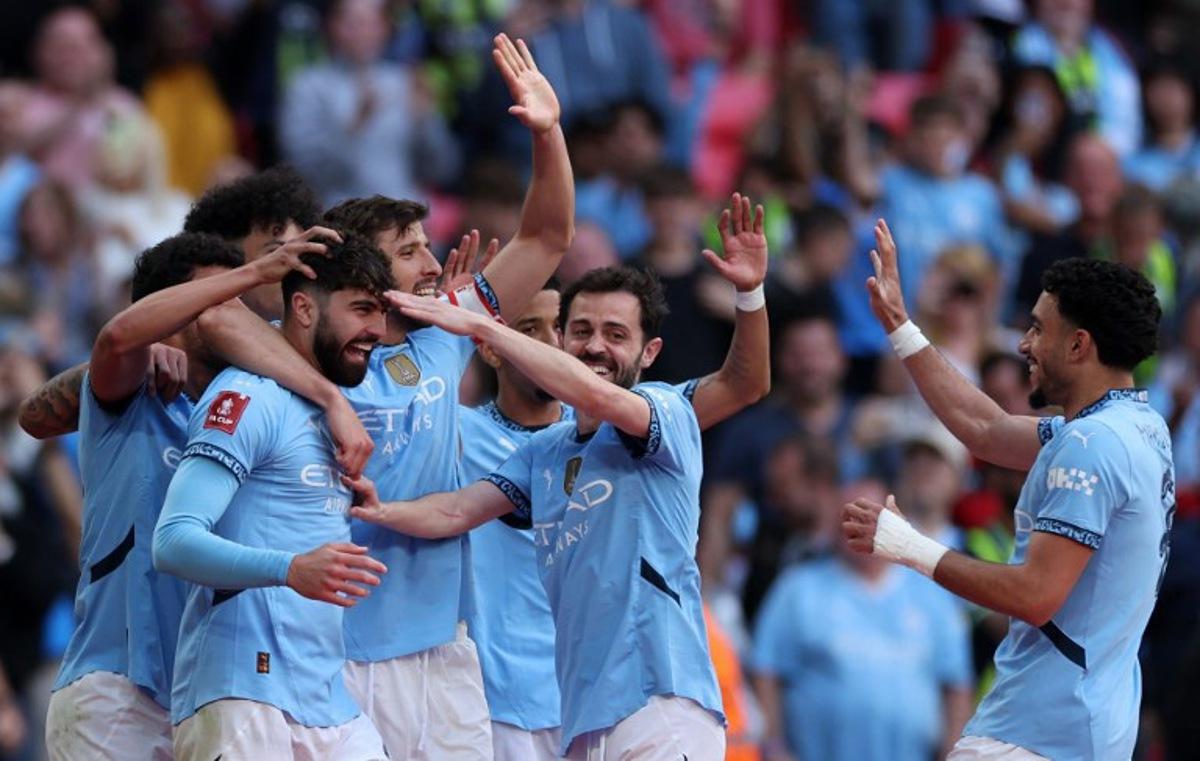 Manchester City's Croatian defender #24 Josko Gvardiol (3L) is mobbed by teammates after scoring the team's second goal during the English FA Cup semi-final football match between Nottingham Forest and Manchester City at Wembley Stadium in north London on April 27, 2025. Adrian Dennis / AFP