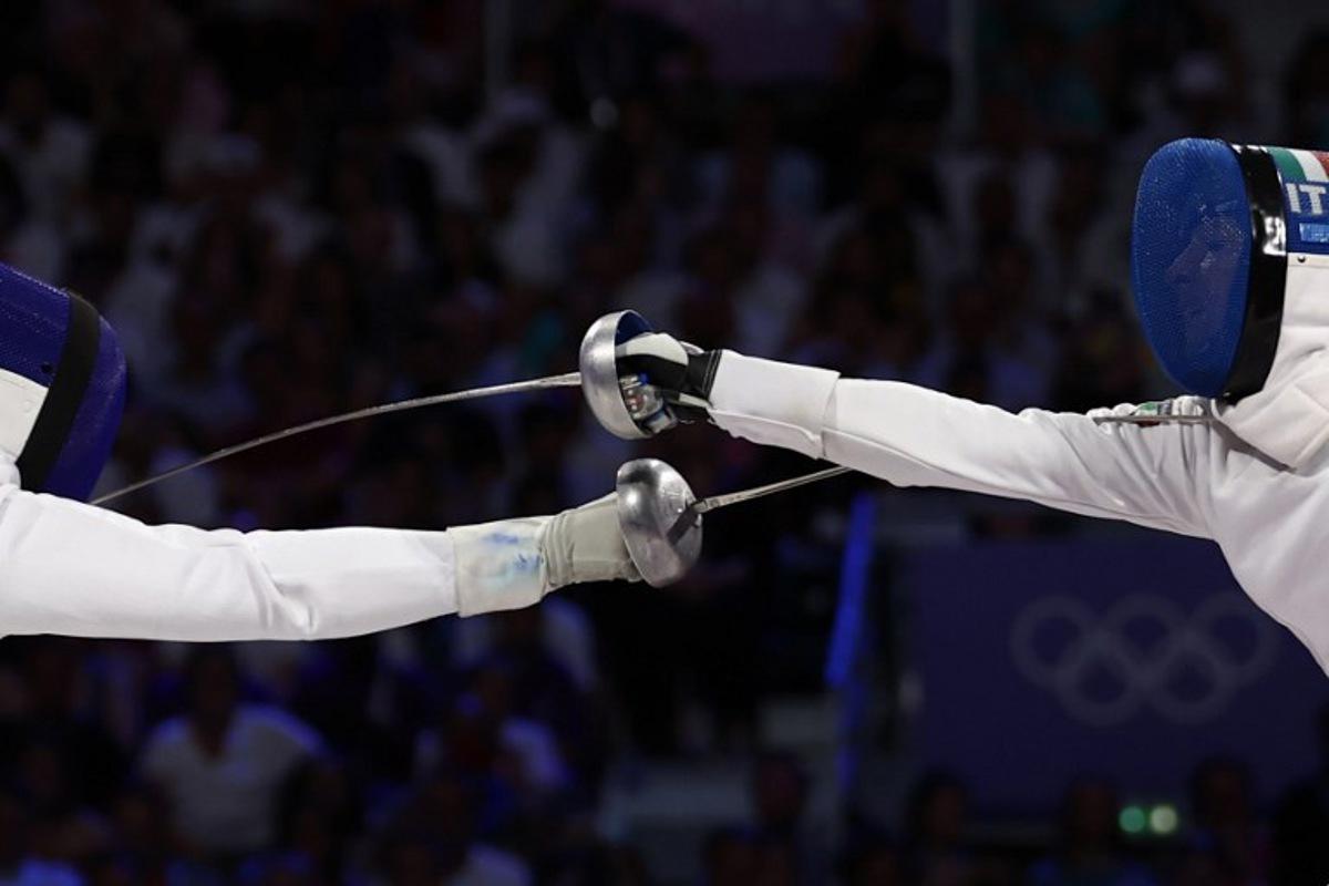 France's Coraline Vitalis (L) competes against Italy's Alberta Santuccio in the women's epee team gold medal bout during the Paris 2024 Olympic Games at the Grand Palais in Paris, on July 30, 2024. Franck FIFE / AFP