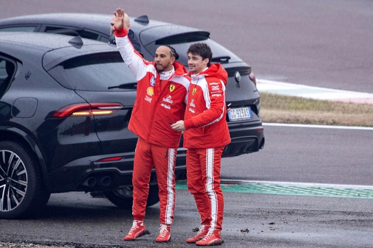 Ferrari's British driver Lewis Hamilton (L) and Ferrari's Monegasque driver Charles Leclerc wave to fans after testing the new Formula 1 Ferrari SF-26 at Fiorano Circuit in Fiorano Modenese on January 23, 2026. Federico SCOPPA / AFP