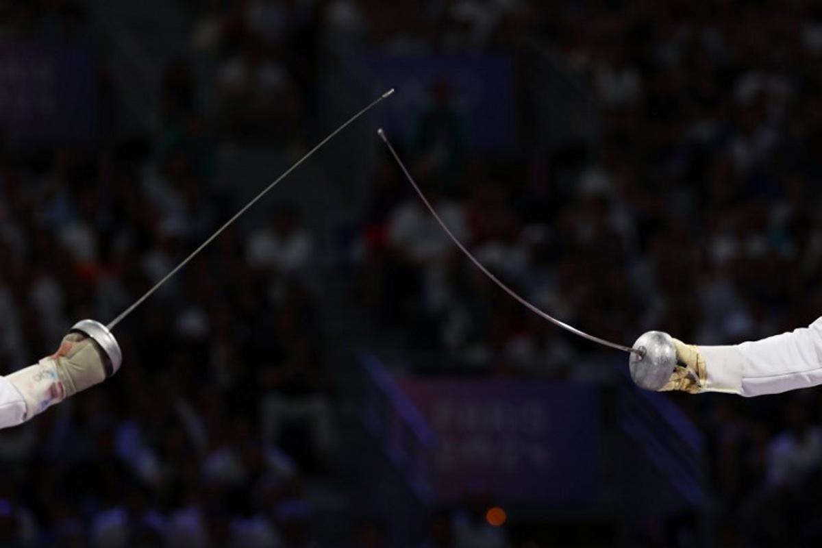 Czech Republic's Jiri Beran (L) competes against France's Yannick Borel in the men's epee team bronze medal bout between Czech Republic and France during the Paris 2024 Olympic Games at the Grand Palais in Paris, on August 2, 2024. Franck FIFE / AFP