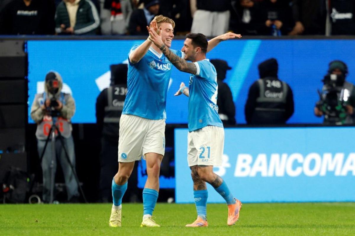 SCC Napoli Rasmus Hojlund (L) celebrates with teammate Matteo Politano after scoring the second goal during the Italian Super Cup semi-final match between SCC Napoli and AC Milan at King Saud University Stadium in Riyadh on December 18, 2025. Fayez Nureldine / AFP