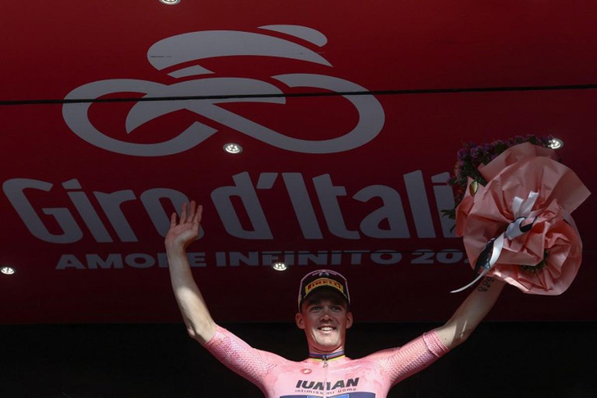 Lidl-Trek's Danish rider Mads Pedersen, wearing the overall leader's pink jersey (Maglia Rosa), celebrates on the podium after the 4th stage of the 108th Giro d'Italia cycling race 189kms from Alberobello to Lecce on May 13, 2025. Luca Bettini / AFP