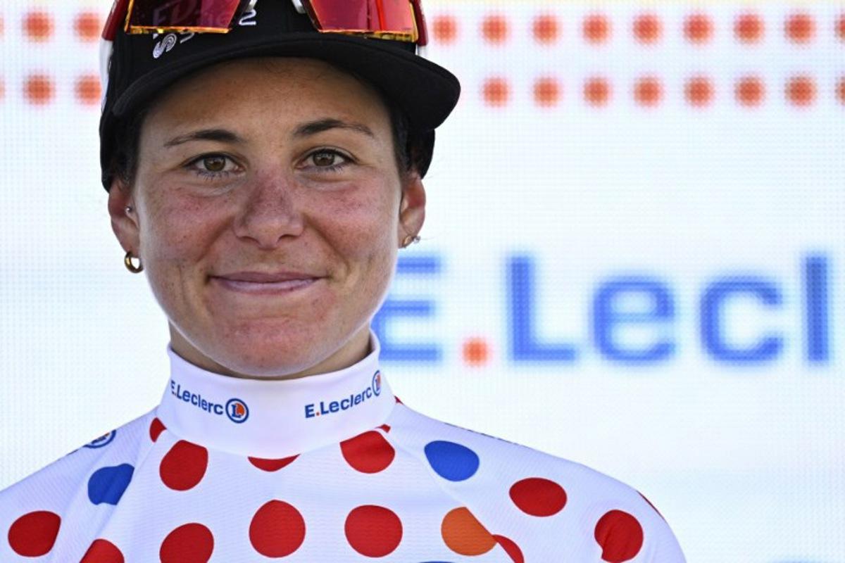 FDJ-SUEZ team's Swiss rider Elise Chabbey celebrates her polka dot best climber's jersey on the podium after the 7th stage (out of 9) of the fourth edition of the Women's Tour de France cycling race, 159.7 km from Bourg-en-Bresse to Chambéry, in Chambéry, south-eastern France on August 1, 2025. JULIEN DE ROSA / AFP