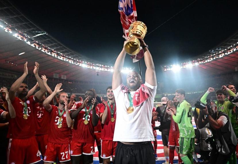 Bayern Munich's Belgian head coach Vincent Kompany lifts the trophy after the German Cup (DFB Pokal) final football match FC Bayern Munich v VfB Stuttgart at the Olympic Stadium in Berlin, on May 23, 2026. Tobias SCHWARZ / AFP