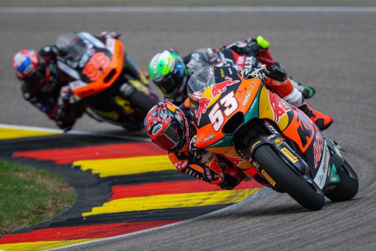 Red Bull KTM Ajo Team's Turkish Moto2 rider Deniz Oncu (R) leads next to Fantic Racing Team's Belgiums Moto2 rider Barry Baltus (C) and Elf Marc VDS Racing Team's Great Britain Moto2 rider Jake Dixon (L) during the German Moto2 Grand Prix at the Sachsenring racing circuit, in Hohenstein-Ernstthal near Chemnitz, eastern Germany on July 13, 2025. Ronny Hartmann / AFP