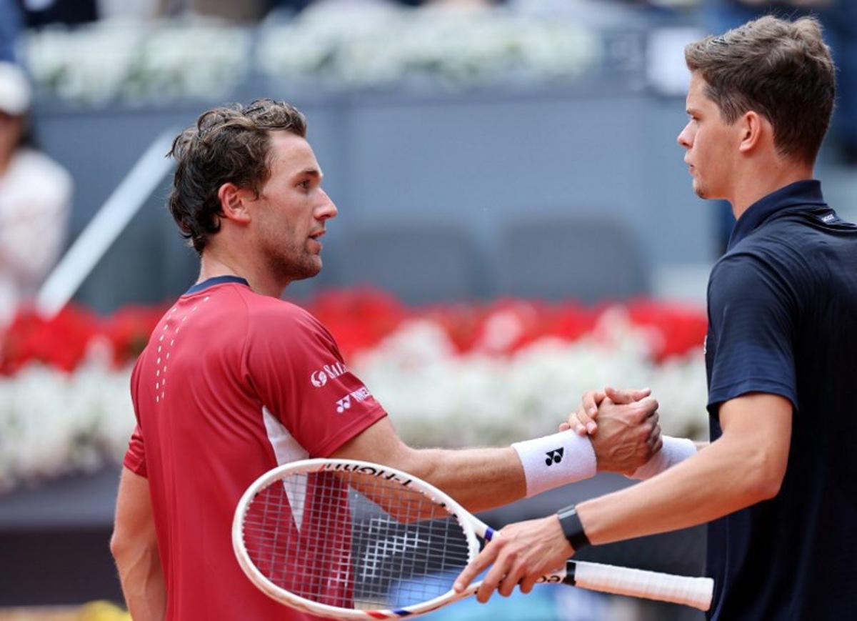 Belgium's Alexander Blockx shakes hands with Norway's Casper Ruud after beating him during their 2026 ATP Tour Madrid Open tennis tournament quarter-final singles match at the Caja Magica in Madrid, on April 30, 2026. Thomas COEX / AFP