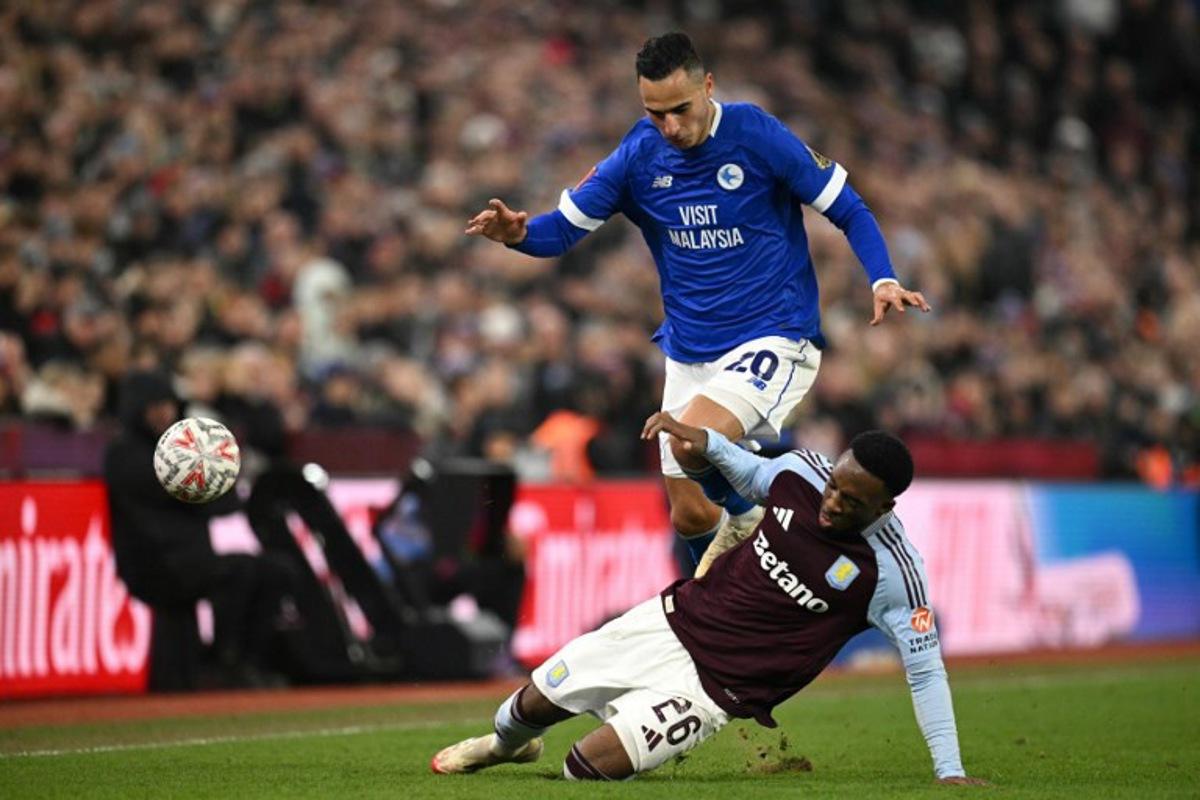 Cardiff City's Dutch striker #20 Anwar El Ghazi battles for the ball with Aston Villa's Dutch midfielder #26 Lamare Bogarde during the English FA Cup fifth round football match between Aston Villa and Cardiff City at Villa Park in Birmingham, central England on February 28, 2025. Oli SCARFF / AFP