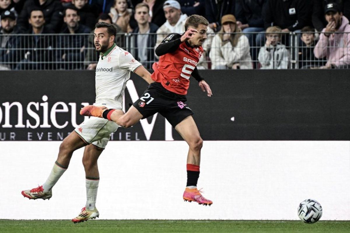 Nice's Belgian midfielder #24 Charles Vanhoutte (L) and Rennes' French midfielder #21 Valentin Rongier fight for the ball during the French L1 football match between Stade Rennais FC and OGC Nice at the Roazhon Park stadium in Rennes, western France on October 26, 2025. Sebastien Salom-Gomis / AFP