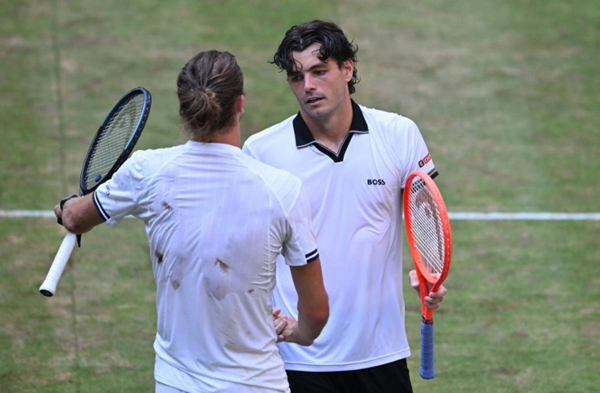 Germany's Alexander Zverev (front) congratulates Taylor Fritz of the US after the men's singles semi-final match of the Halle Open ATP tennis tournament in Halle, western Germany, on June 20, 2026. Taylor wins 7-6, 4-6,5-7. CARMEN JASPERSEN / AFP